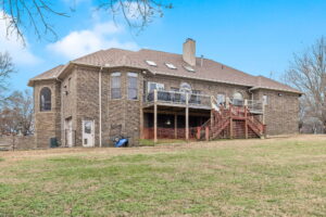 Rear view of the home at 1069 Windsor Drive, Gallatin, TN, showing the pool and landscaped yard.