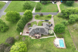 Aerial view of the backyard at 1069 Windsor Drive, featuring 2 acres and an in-ground pool.